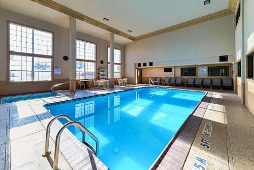 a large indoor swimming pool with blue water at Quality Inn & Suites Lubbock South in Lubbock