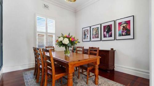 a dining room table with a vase of flowers on it at Charming Heritage Retreat in Sale