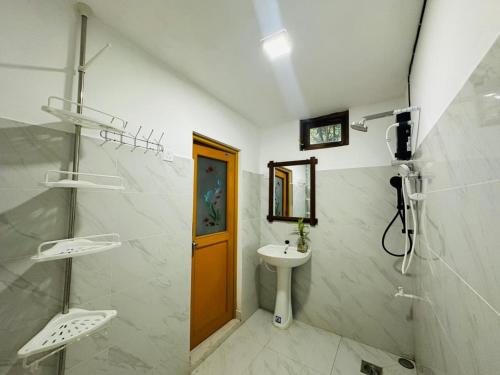 a bathroom with a sink and a toilet and a mirror at Sigiri Gateway in Galewela