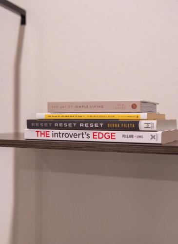 a stack of books sitting on a shelf at South Shore Suites in Wimauma