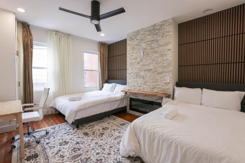 a bedroom with two beds and a brick wall at The Inn at Dupont in Washington, D.C.