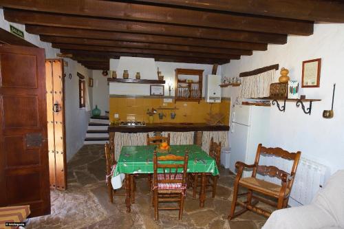a kitchen with a table and chairs in a room at Rancho Calvillo in Prado del Rey