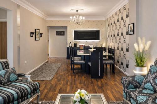 a living room with a table and a dining room at Arabella Residence 2BR - New Cairo Luxury Stay in Cairo