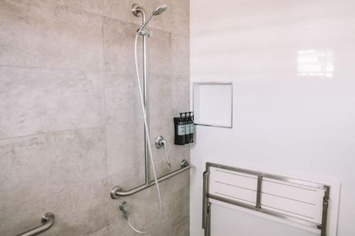 a shower stall in a bathroom with a shower head at Salt @ South West Rocks in South West Rocks