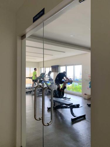 a mirror in a room with people in a gym at Mountain View Studio at Marina Spatial - 300Mbps, Pool, City Centre in Dumaguete