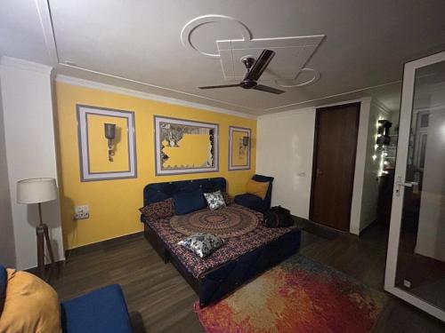 a living room with a couch and a bed at Gurgaon 21 Tonic & Twinkle in Gurgaon