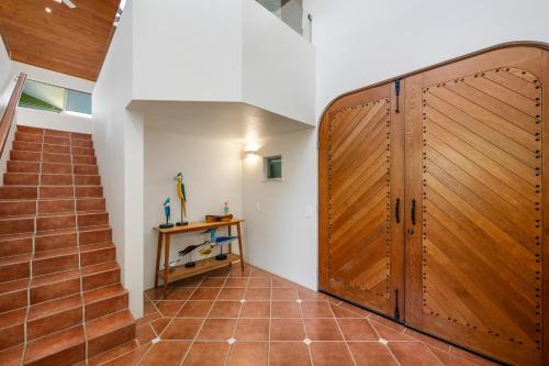 a hallway with a wooden door in a house at Beachside Bliss - Ocean View, Pool, Sauna in Peregian Beach