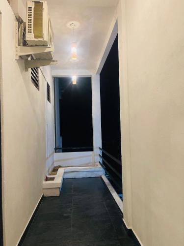 an empty hallway with a window in a building at Luminozo Beach Hotel in Weligama