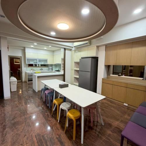 a kitchen with a table and chairs and a refrigerator at Lingering Light #預定後請聯繫 in Tainan