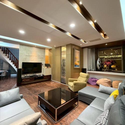 a living room with a couch and a tv at Lingering Light #預定後請聯繫 in Tainan