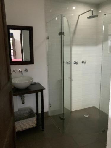 a bathroom with a glass shower and a sink at Finca San Pablo in Subachoque