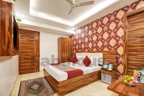 a hotel room with a bed and a television at Hotel Fabulous - Delhi International Airport in New Delhi