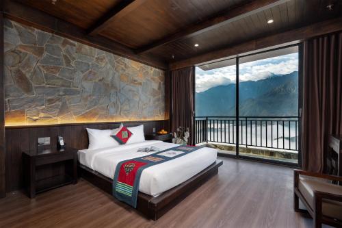 a bedroom with a bed and a large window at TIME Restaurant & Homestay Sa Pa in Sapa