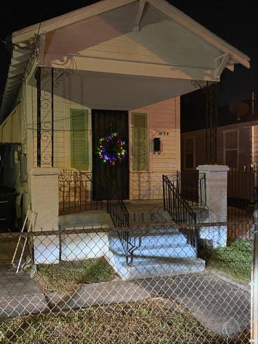 a house with a christmas wreath on the front door at Traditional Nola in New Orleans