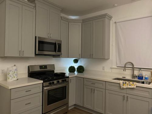 a kitchen with white cabinets and a stove top oven at Traditional Nola in New Orleans