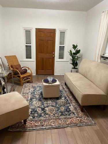 a living room with a couch and a rug at Traditional Nola in New Orleans