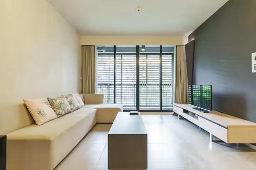a living room with a couch and a table at Circle S Sukhumvit 12 Bangkok in Bangkok