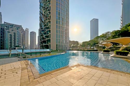 a swimming pool in a city with tall buildings at Burj Khalifa View Apartments, Burj Vista Tower - Downtown in Dubai