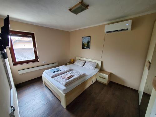 a small bedroom with a bed and a window at DVOR seosko turisticko domacinstvo in Donja Toponica