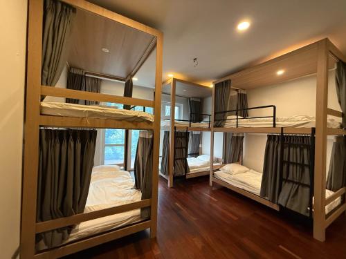 a room with three bunk beds in a room at Spuds&Bunks Hostel in Hanoi