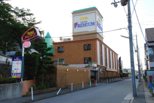 a building with a sign on the top of it at ホテル アイアンプレミアム 西宮北店 男塾ホテルグループ in Nishinomiya