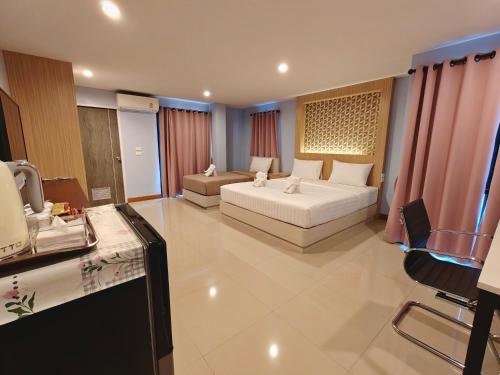 a large room with a bed and a couch at TK Thongrak Apartment in Hat Yai