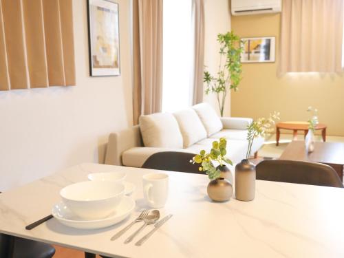 a living room with a table with dishes on it at 9stay 富士河口湖 in Fujikawaguchiko