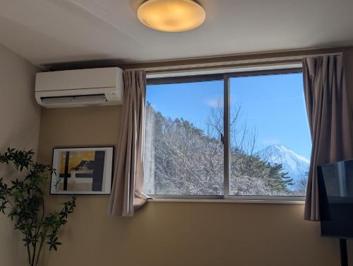 a room with a window with a mountain view at 9stay 富士河口湖 in Fujikawaguchiko