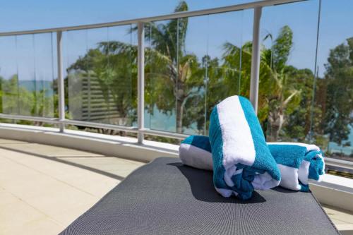 a pair of towels sitting on top of a balcony at Oceanview Oasis in Urangan
