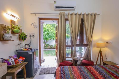 a bedroom with a bed and a sliding glass door at Matrika Homestay in Lucknow