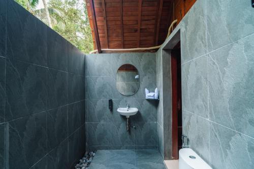 a bathroom with a sink and a mirror at Udaka Retreat in Payangan
