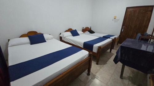 a room with two beds in a room at Stay Suite in Mahiyangana