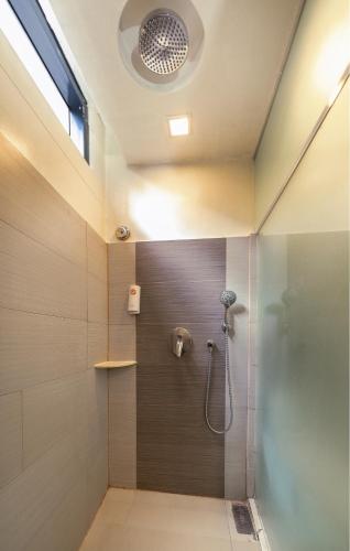 a bathroom with a shower with a glass door at Go Hotels Ortigas Center in Manila