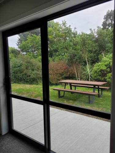 a view of a picnic table from a window at Clearwater Private Guest Suite in Dunedin