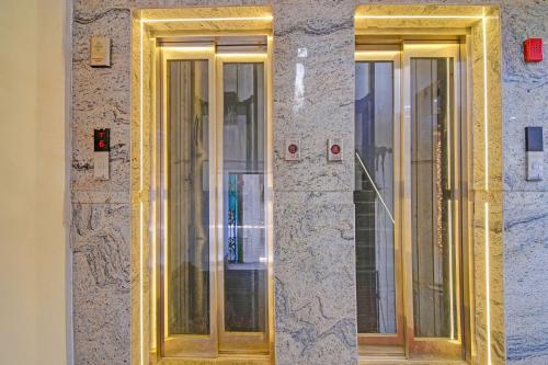 a building with three glass doors on a wall at FabHotel Disa in kolkata