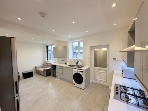 a kitchen with a sink and a dishwasher at Precious House 2 in Leicester