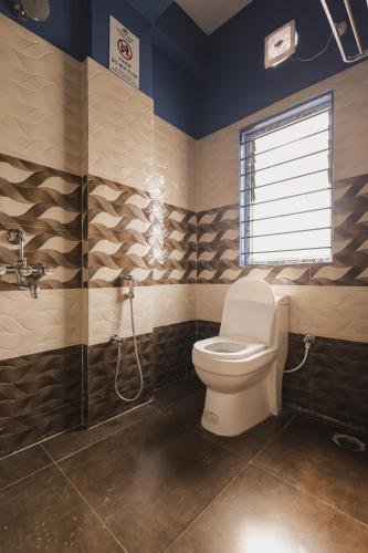 a bathroom with a toilet and a shower at Lotus Leaf GuestHouse in Guwahati