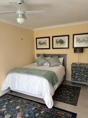 a bedroom with a bed with white sheets and pillows at Hyalus House in Vaal Marina