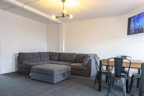 a living room with a couch and a table at Clock Tower Accommodation in Hokitika