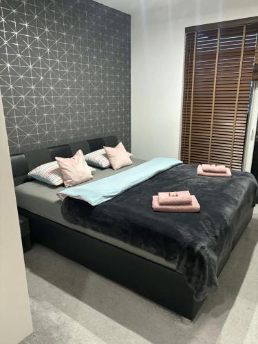 a bed in a room with two towels on it at Súkromný apartmán in Senec