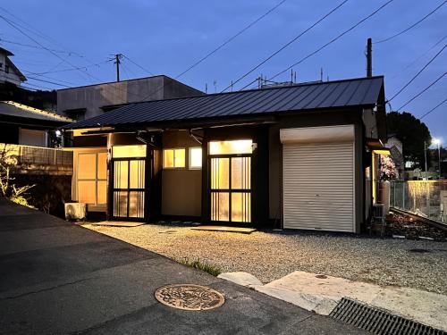a house with a garage and a manhole istg at Ajito in Okayama