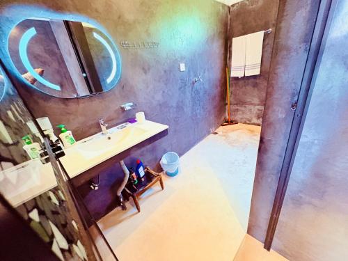 a bathroom with a sink and a mirror at Shehan Villa in Beruwala