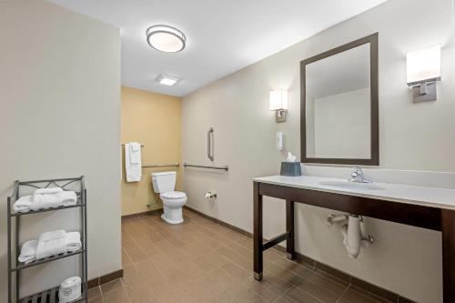 a bathroom with a sink and a toilet and a mirror at Sleep Inn & Suites Jasper I-22 in Jasper