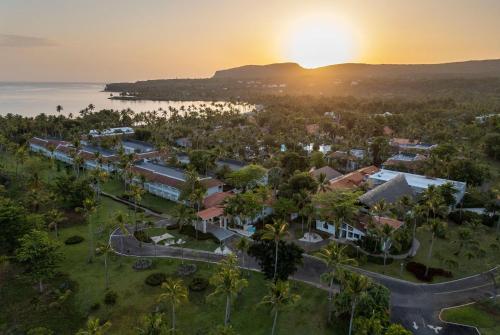 an aerial view of a resort with the sunset at Wyndham Alltra Samana All Inclusive Resort in Las Galeras