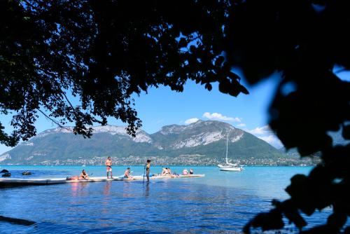 a group of people on boats in the water at L'Aurore du Lac in Sévrier