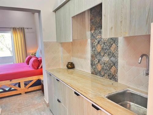 a kitchen with a sink and a counter top at Vasantvasoj Homestay in Pauri