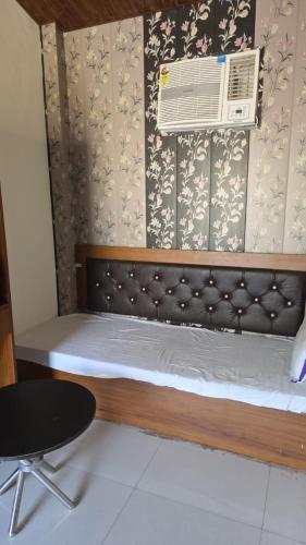 a bedroom with a bed with a air conditioner at The Jungle Castle Resort in Rāmnagar