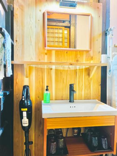 a bathroom with a sink and a microwave at 古都庵Koto-an Japanese Town house in Kyoto
