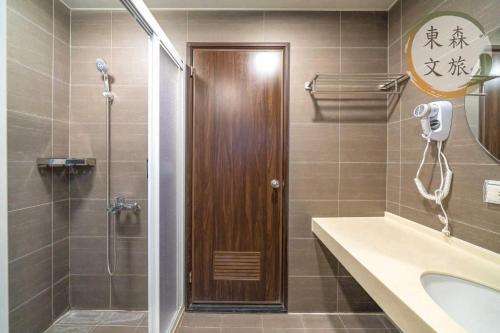 a bathroom with a shower and a glass door at 遇見礁溪-寵物友善-免費停車-無門禁24小時進出-東森文旅-包棟優惠中 in Jiaoxi