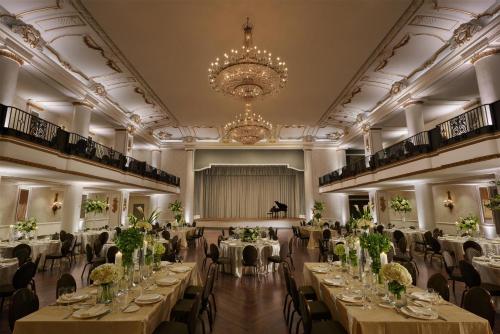a banquet hall with tables and chairs and a chandelier at The Bellevue Hotel, in the Unbound Collection by Hyatt in Philadelphia